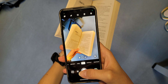 Picture of a Phone taking a picture of a book