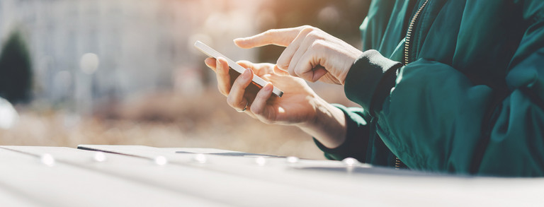  A person types in something on a smartphone