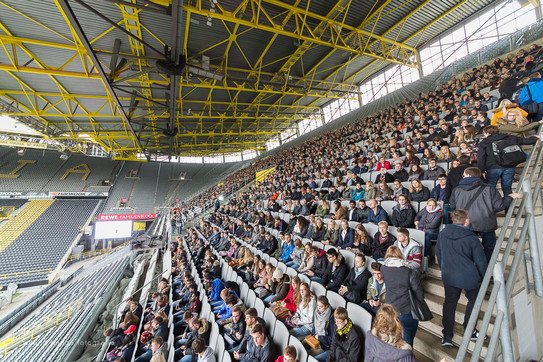 First semester students sit in the stands at the stadium during the welcoming of first-semester students.