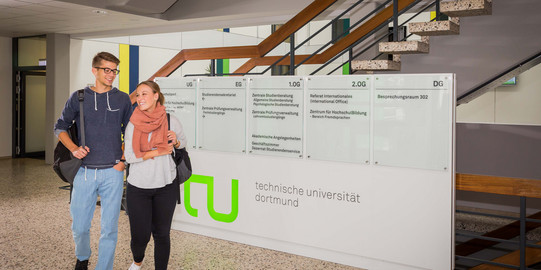 Two students walk through the foyer.