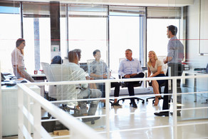 six people sitting together in a bright room are facing each other